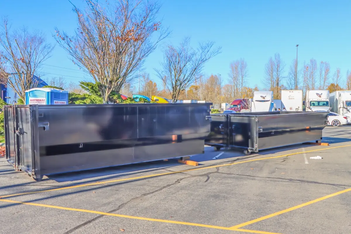 Professional dumpster rental service with roll-off container on residential driveway in Dundalk